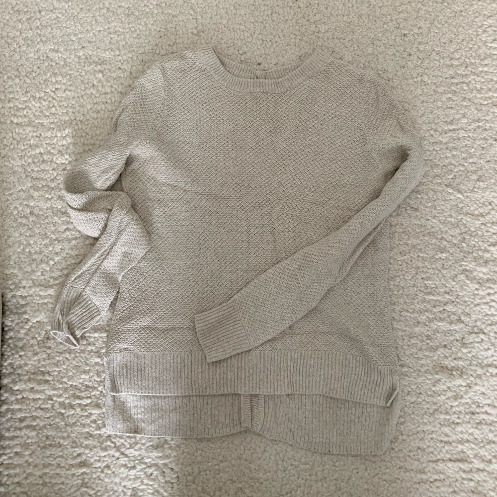 Cream colored sweater with button back detail